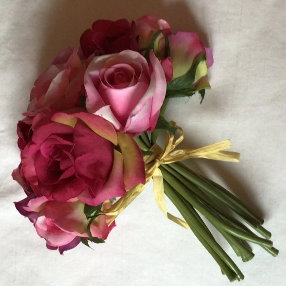 Bouquet of artificial roses tied with a raffia ribbon